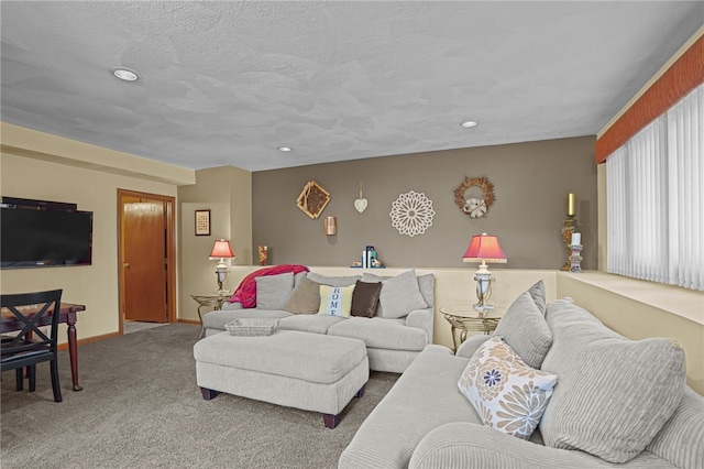 living room featuring carpet floors and a textured ceiling