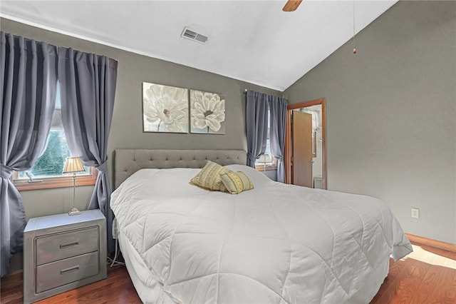 bedroom featuring ceiling fan, dark hardwood / wood-style floors, and vaulted ceiling