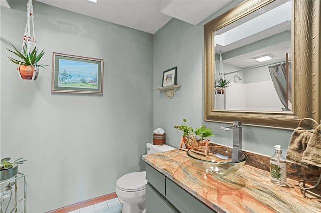 bathroom featuring vanity, tile patterned floors, and toilet