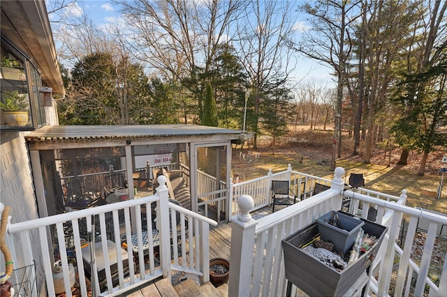 wooden deck featuring a sunroom