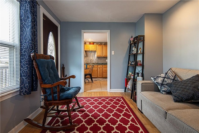 living room with sink and light hardwood / wood-style flooring