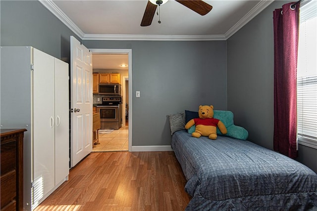 bedroom with crown molding, ceiling fan, and light wood-type flooring