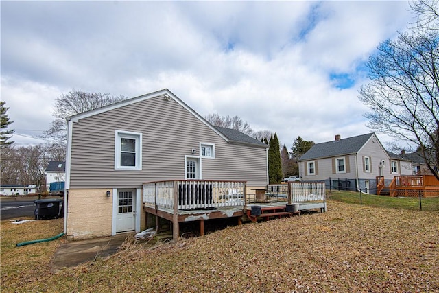 back of house with a yard and a deck