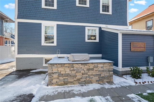 snow covered patio with area for grilling