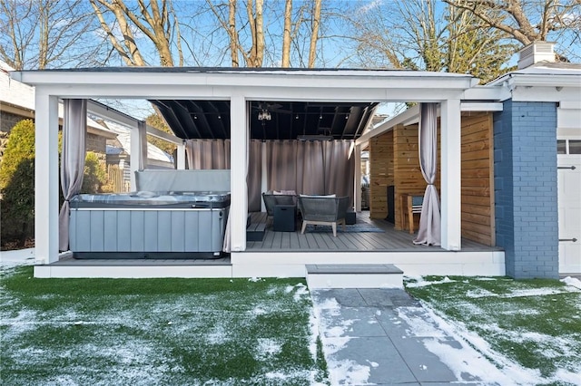 wooden terrace with a hot tub