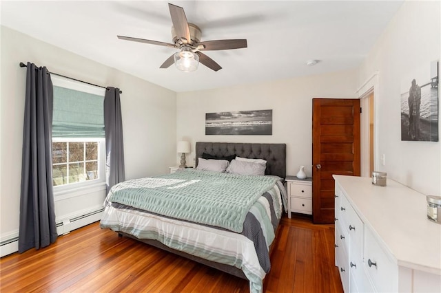 bedroom with light wood-type flooring, ceiling fan, and baseboard heating