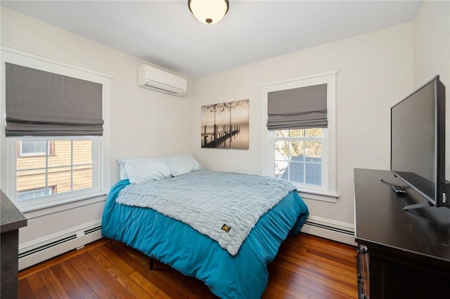 bedroom with dark hardwood / wood-style flooring, a baseboard heating unit, and an AC wall unit