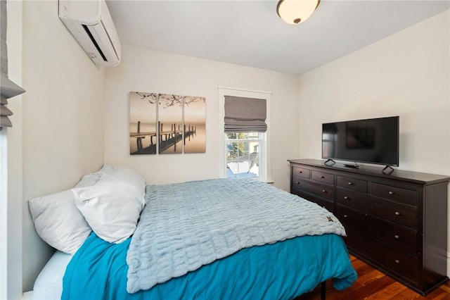 bedroom featuring an AC wall unit and dark wood-type flooring