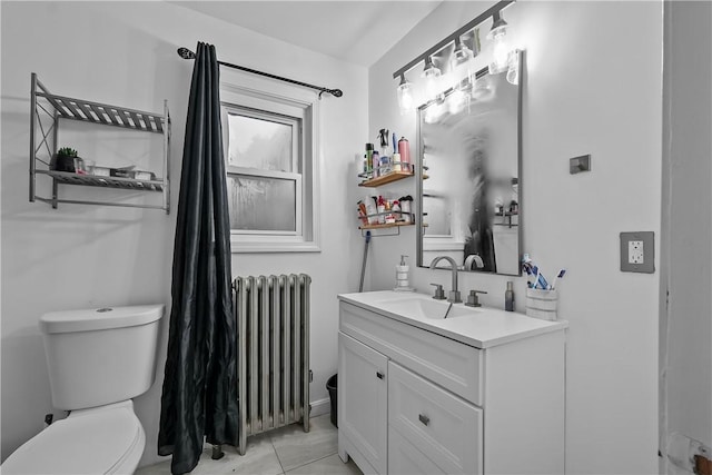 bathroom with vanity, toilet, and radiator