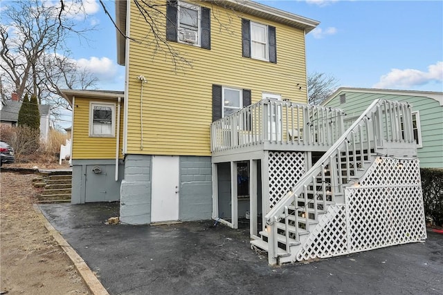 back of house with a wooden deck