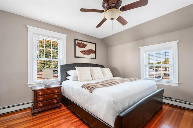 bedroom with hardwood / wood-style flooring, a baseboard radiator, lofted ceiling, and ceiling fan