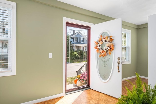 doorway to outside featuring light parquet floors