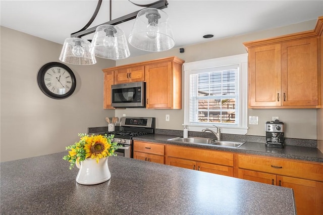 kitchen featuring pendant lighting, sink, and stainless steel appliances