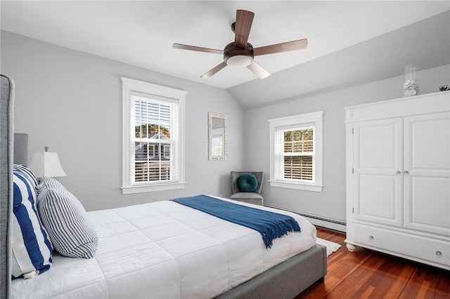 bedroom with vaulted ceiling, ceiling fan, dark hardwood / wood-style flooring, and baseboard heating