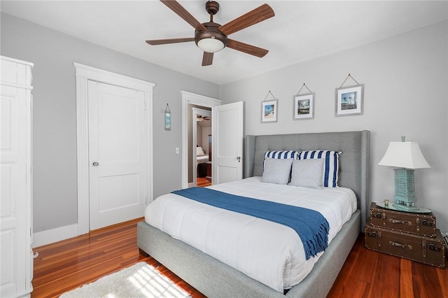 bedroom featuring a closet, dark hardwood / wood-style floors, and ceiling fan