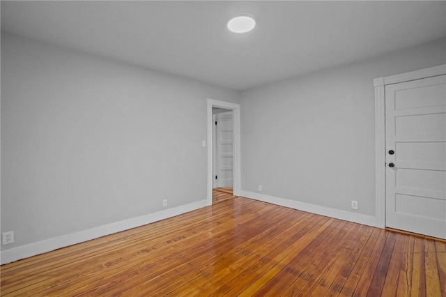 spare room with hardwood / wood-style floors