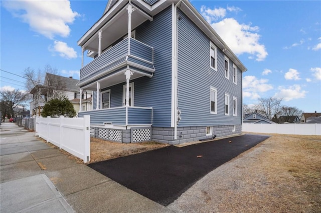 view of property exterior with a balcony and covered porch