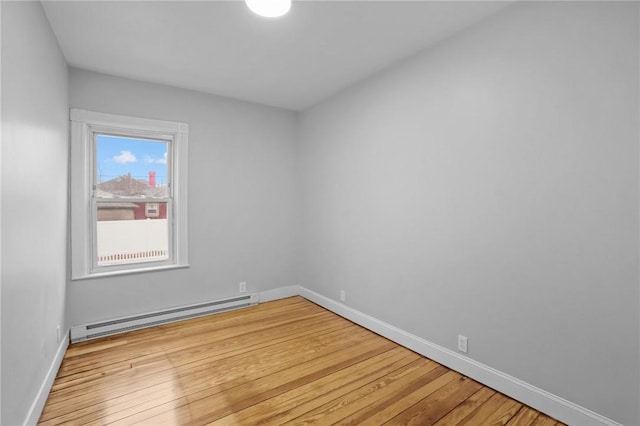 empty room featuring light hardwood / wood-style floors and baseboard heating