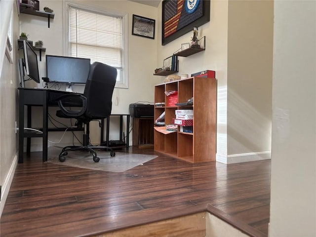 home office with dark hardwood / wood-style flooring