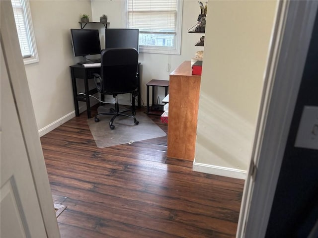 office space with dark wood-type flooring