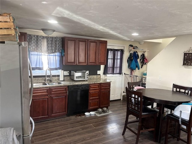 kitchen with black dishwasher, sink, stainless steel fridge, dark hardwood / wood-style flooring, and light stone countertops