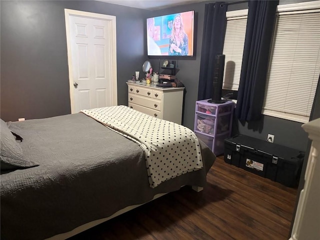 bedroom with dark wood-type flooring