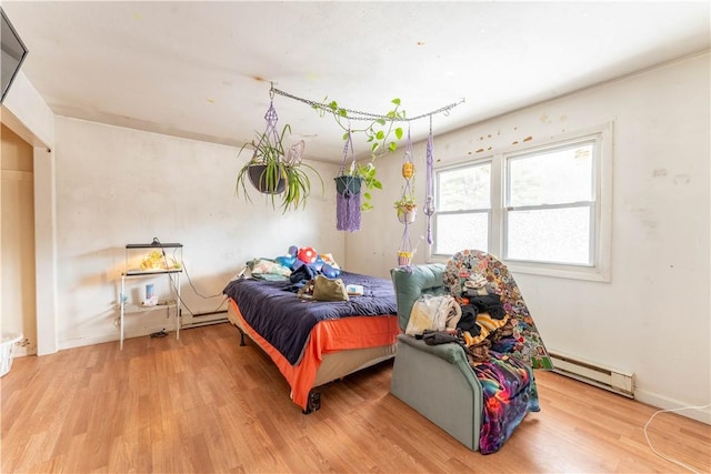 bedroom featuring a baseboard radiator and hardwood / wood-style floors