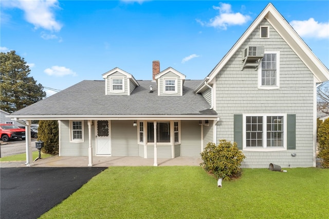 view of front facade with covered porch and a front yard