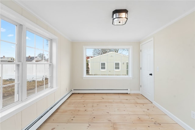 unfurnished sunroom with a healthy amount of sunlight and a baseboard heating unit