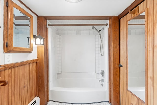 bathroom with wooden walls and bathtub / shower combination