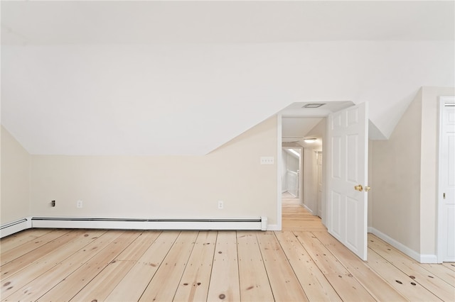 bonus room featuring vaulted ceiling, light hardwood / wood-style floors, and baseboard heating