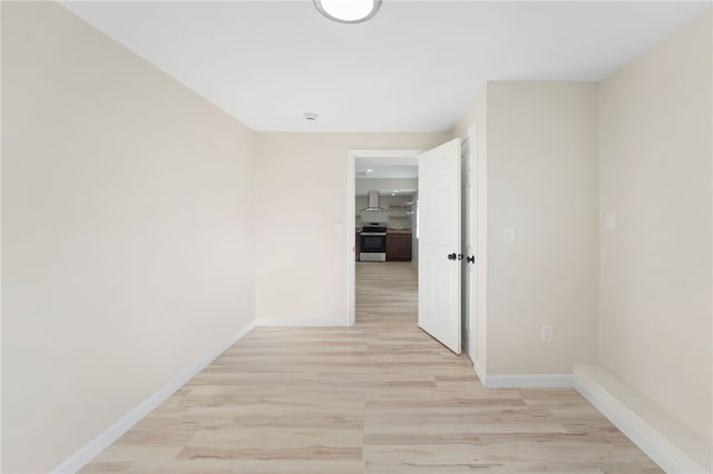 hallway with light hardwood / wood-style floors