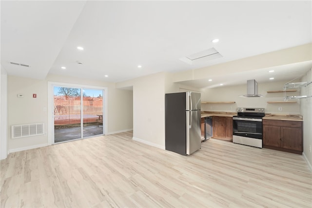 kitchen with appliances with stainless steel finishes, light wood-type flooring, and exhaust hood