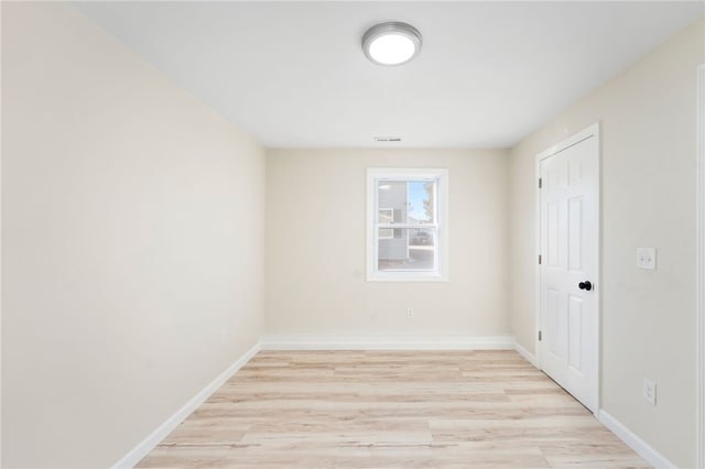 spare room featuring light hardwood / wood-style flooring