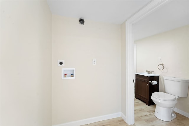 clothes washing area with sink, hookup for an electric dryer, light hardwood / wood-style floors, and hookup for a washing machine