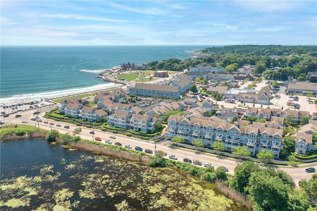 bird's eye view with a water view and a beach view