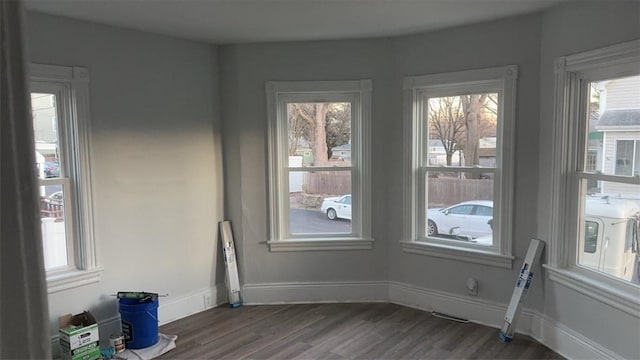 unfurnished room featuring dark hardwood / wood-style flooring