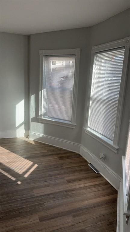 empty room featuring dark wood-type flooring