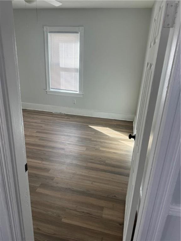 unfurnished room with dark wood-type flooring