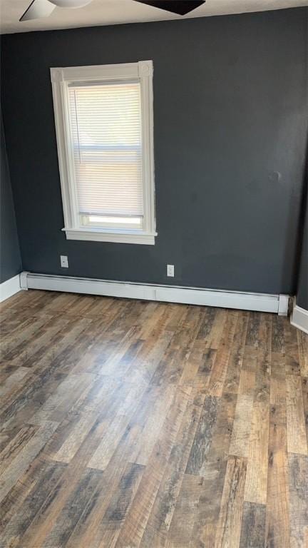 spare room featuring hardwood / wood-style flooring, a baseboard radiator, and ceiling fan