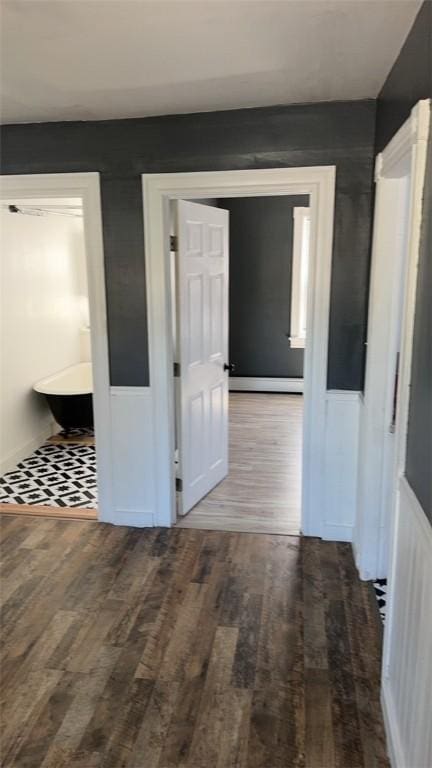 corridor with hardwood / wood-style floors