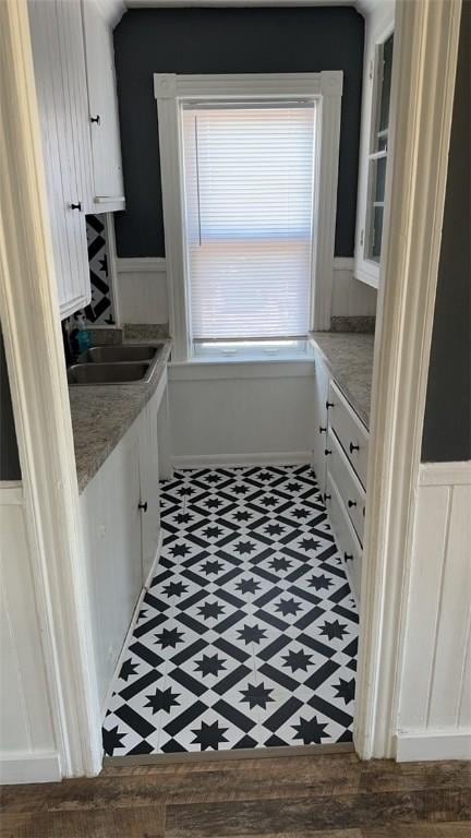 kitchen featuring sink and white cabinets