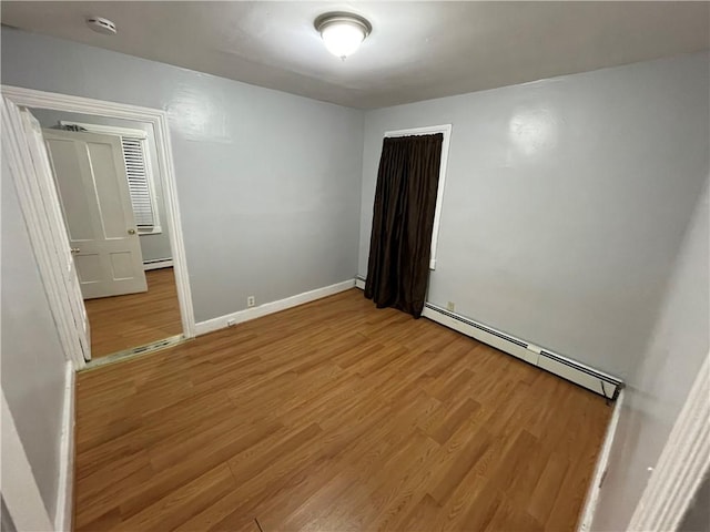 interior space featuring hardwood / wood-style flooring and baseboard heating