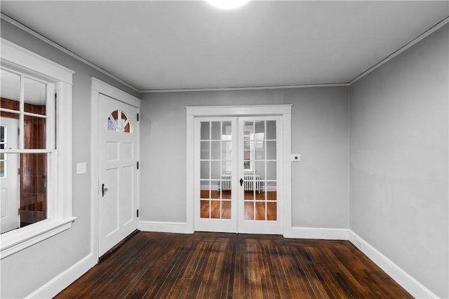 interior space with crown molding, dark wood-type flooring, and french doors