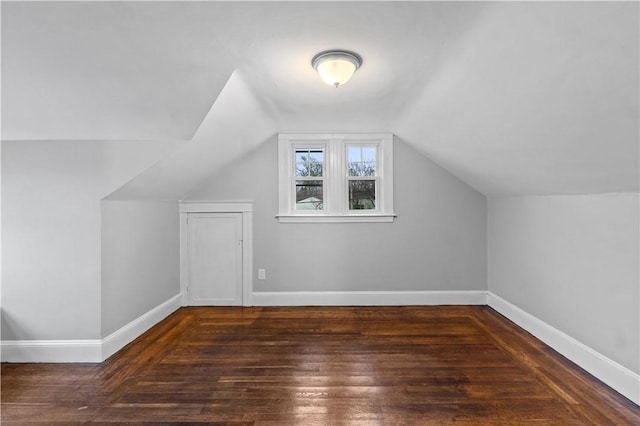 bonus room featuring vaulted ceiling and dark hardwood / wood-style flooring