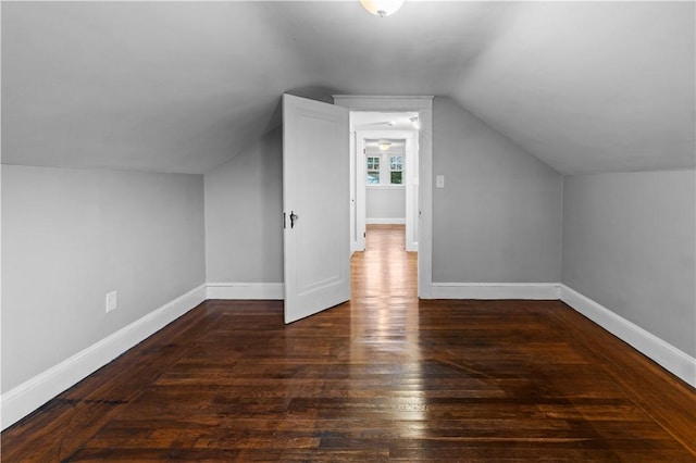 additional living space featuring lofted ceiling and dark hardwood / wood-style floors