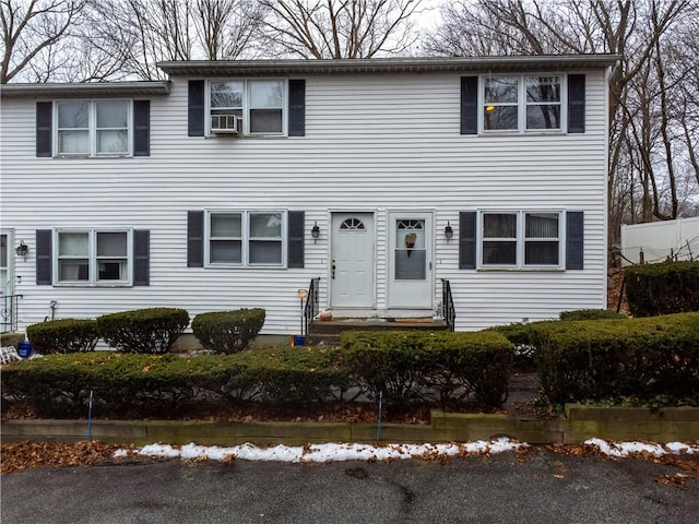 colonial home featuring cooling unit