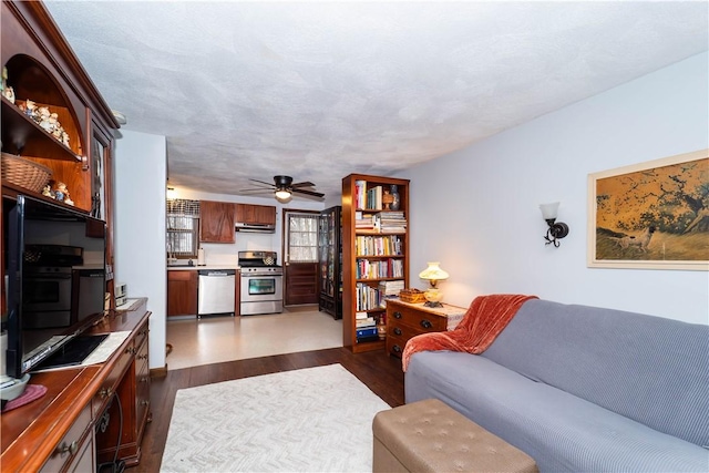 living room featuring dark hardwood / wood-style floors and ceiling fan