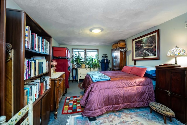 bedroom with a textured ceiling and carpet