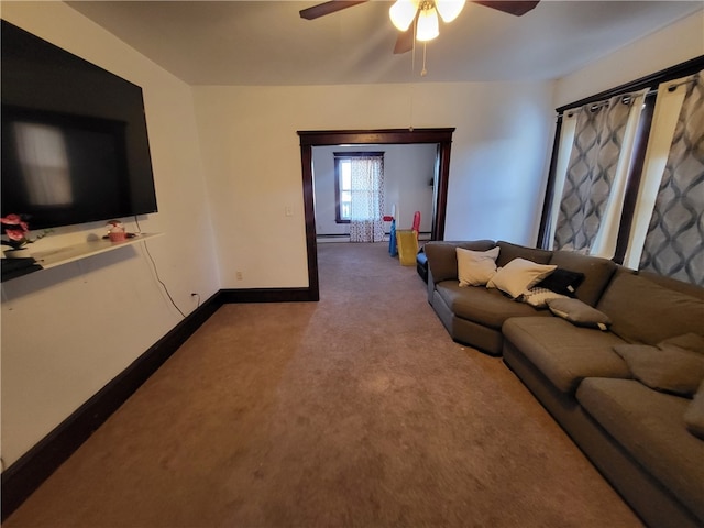 carpeted living room with ceiling fan